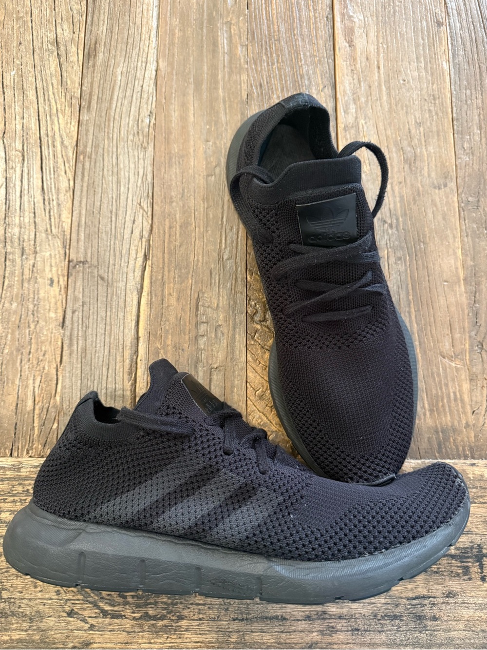 adidas Swift Run Primeknit shoes in a "Triple Black" colorway